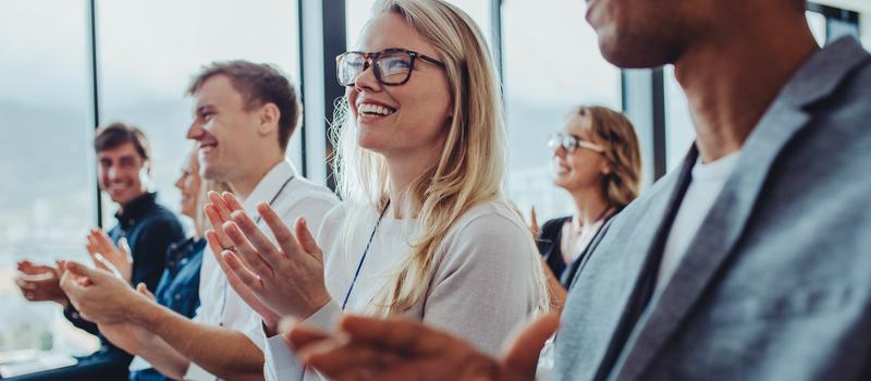Fachleute aus der Wirtschaft applaudieren bei einem Seminar